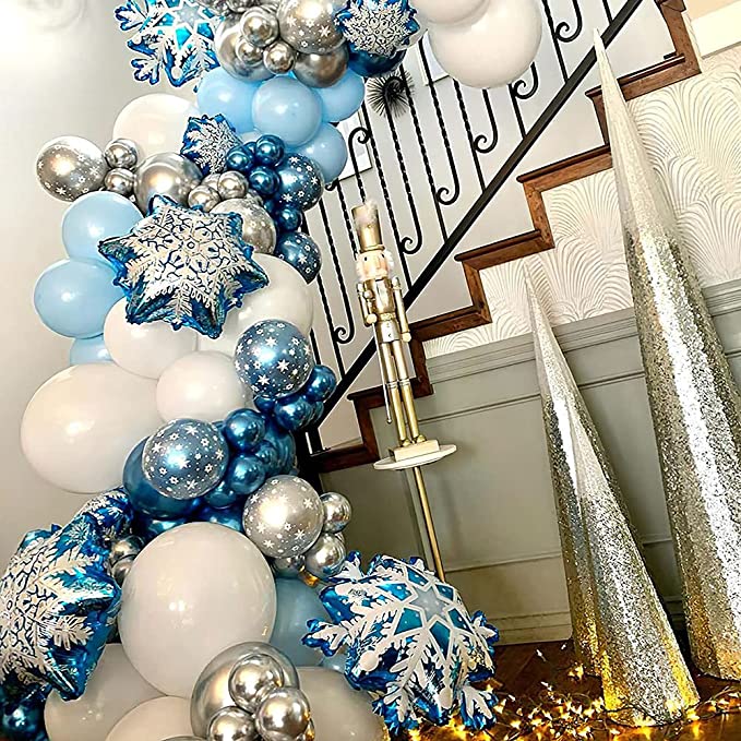 Winter holiday balloon garland with blue and white balloons, snowflake balloons and toy soldier and silver tree ornaments