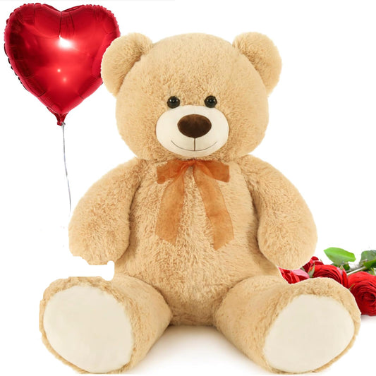A large light brown teddy bear with a heart shaped balloon surrounded by red roses