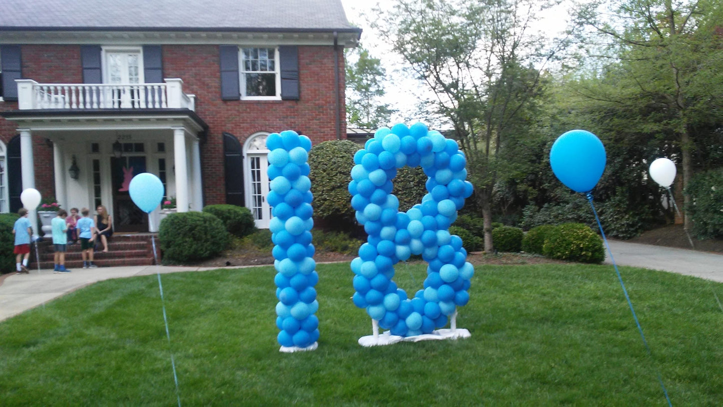 large balloon sculpture  number 19 made with assorted  blue balloons on a lawn in front of a house with floating white and blue helium balloons