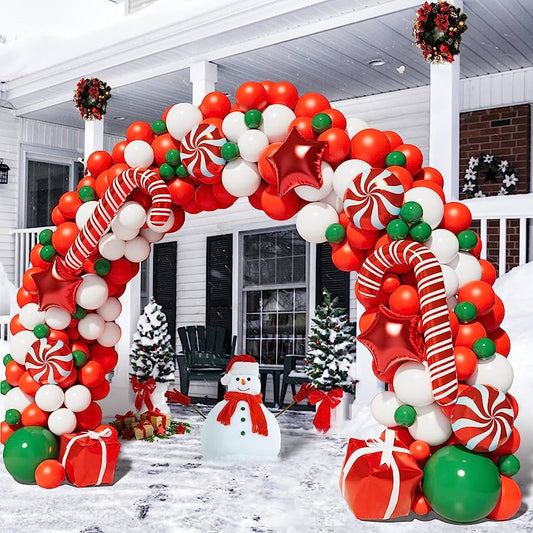 Balloon arch with candy canes, peppermint candy, and gifts.  Balloon arch is outside in front of a house