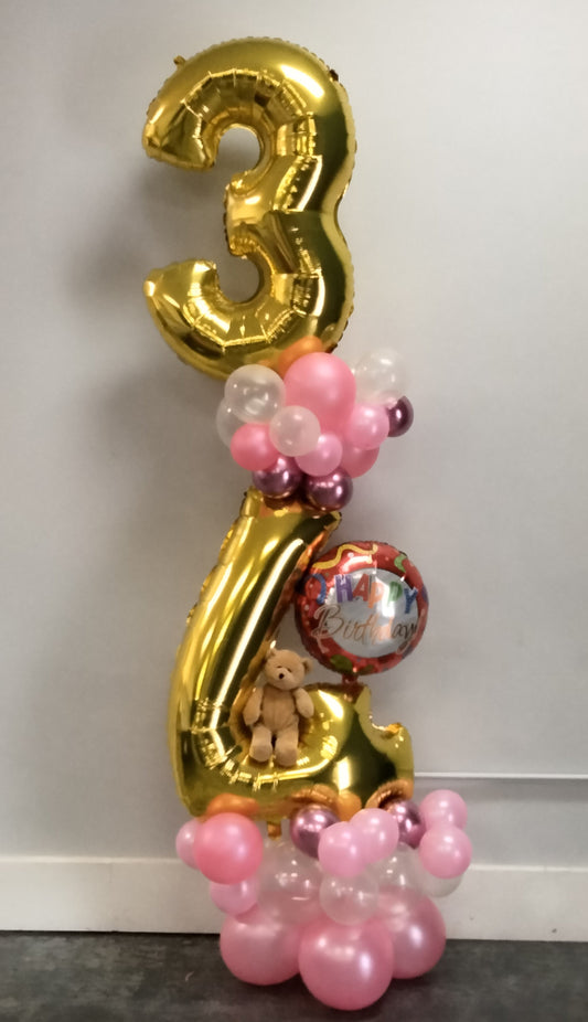 Large gold foil mylar balloon numbers in an arrangement with pink and clear balloons, happy birthday foil and teddy bear






