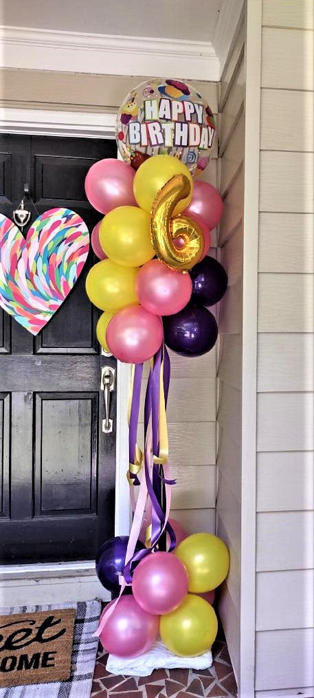 Happy Birthday Pom Pom Balloon column with Happy birthday balloon on top created with pink, yellow and purple balloons with pink, yellow and purple ribbon with a gold number 6 on it