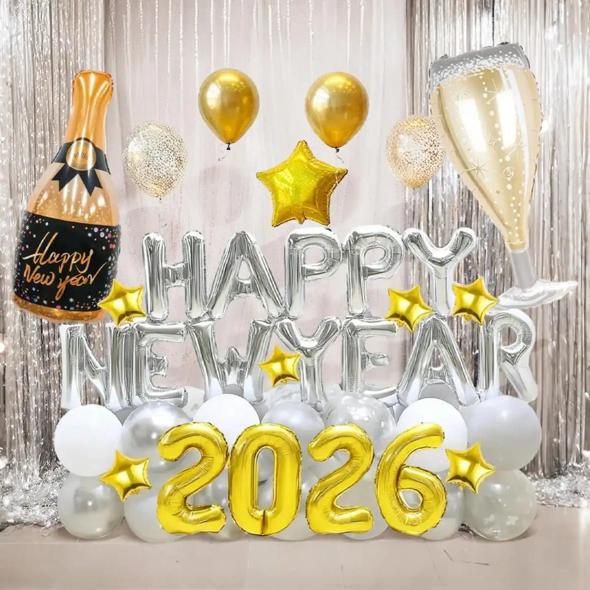 Shiny gold and silver foil balloon centerpiece with “happy new year” letters, champagne bottle and glass shapes, and star accents.