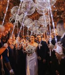 wedding bride and groom walking through arch of LED lights